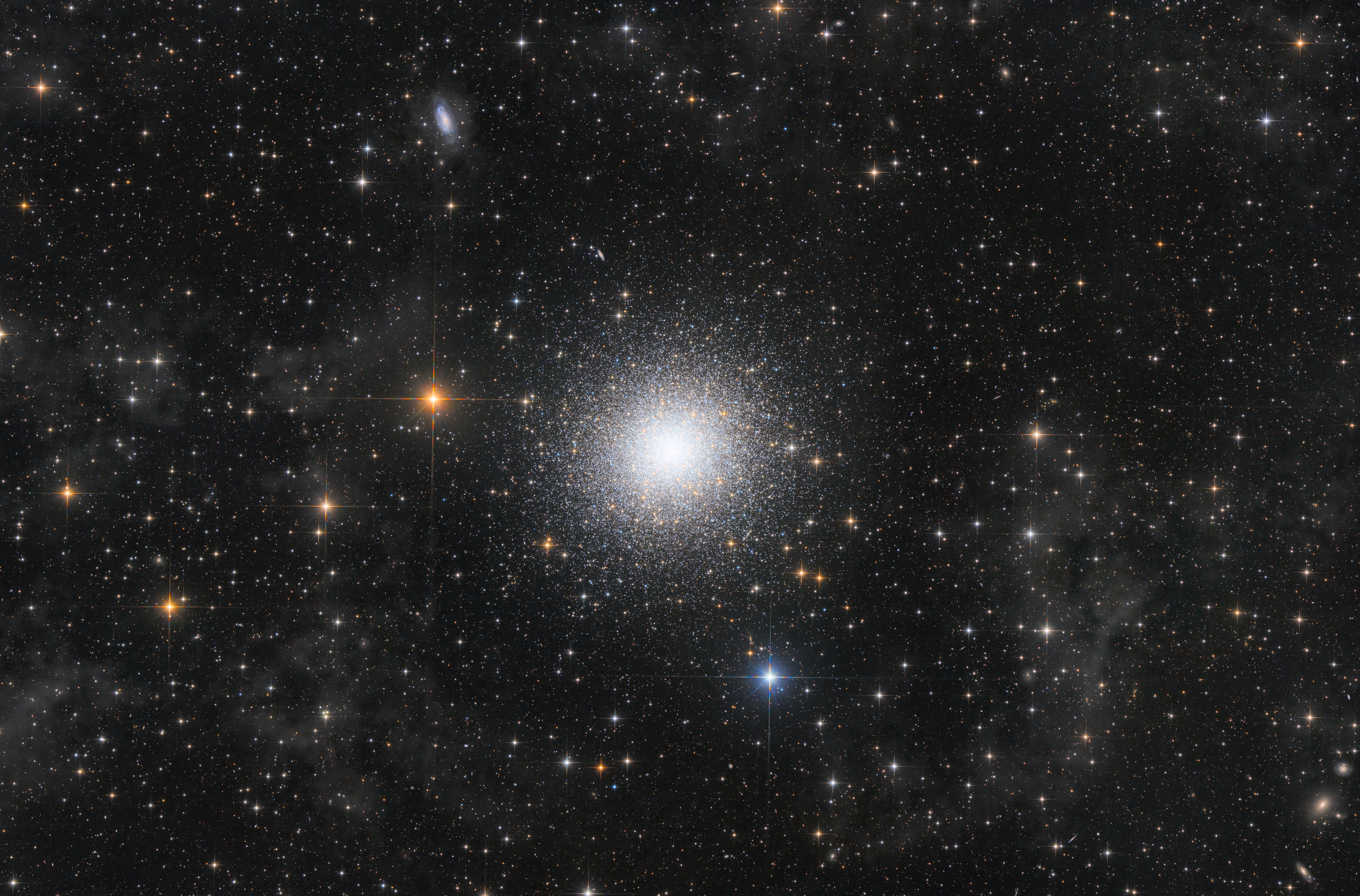 the cluser is a roughly spherical collections of stars - it is surrounges by other many other stars but more spreadout and several gas clouds.